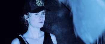 Movie still from “Pitch Black” (2000), directed by David Twohy – A woman wearing a hat and a tank top; Close Up shot, Low angle