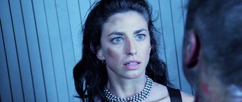 Movie still from “Pitch Black” (2000), directed by David Twohy – A person wearing a pearl necklace; Close Up shot, Low angle