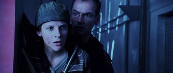 Movie still from “Pitch Black” (2000), directed by David Twohy – A man and a woman standing next to each other; Close Up shot, Low angle