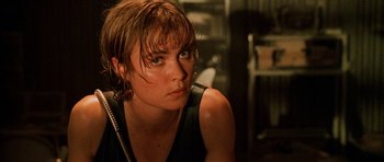 Movie still from “Pitch Black” (2000), directed by David Twohy – A person wearing a black shirt; Close Up shot, Over the shoulder angle