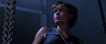 Movie still from “Pitch Black” (2000), directed by David Twohy – A person wearing a tank top; Close Up shot, Low angle