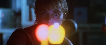 Movie still from “Pitch Black” (2000), directed by David Twohy – A person with a flashlight in a room; Close Up shot, Low angle
