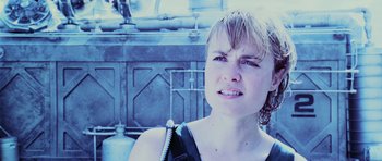 Movie still from “Pitch Black” (2000), directed by David Twohy – A young woman with short blonde hair is crying; Close Up shot, Over the shoulder angle