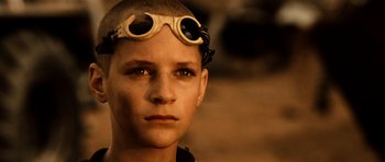 Movie still from “Pitch Black” (2000), directed by David Twohy – A young man wearing goggles and a helmet; Close Up shot, High angle