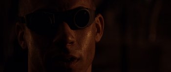 Movie still from “Pitch Black” (2000), directed by David Twohy – A person wearing goggles; Extreme Close Up shot, Low angle
