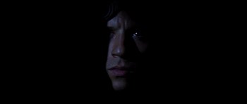 Movie still from “Pitch Black” (2000), directed by David Twohy – A person's face in the dark; Extreme Close Up shot, Overhead angle