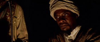 Movie still from “Pitch Black” (2000), directed by David Twohy – A person wearing a headdress; Close Up shot, Low angle