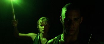 Movie still from “Pitch Black” (2000), directed by David Twohy – A man and a woman in a dark room; Close Up shot, Low angle