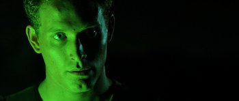 Movie still from “Pitch Black” (2000), directed by David Twohy – A person in a dark room; Close Up shot, Low angle