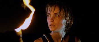 Movie still from “Pitch Black” (2000), directed by David Twohy – A person with a fire in the background; Close Up shot, Low angle