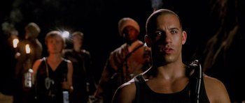 Movie still from “Pitch Black” (2000), directed by David Twohy – A group of men standing next to each other in the dark; Close Up shot, Low angle