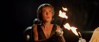 Movie still from “Pitch Black” (2000), directed by David Twohy – A woman is holding a lit stick with flames; Close Up shot, Low angle
