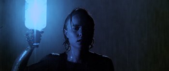 Movie still from “Pitch Black” (2000), directed by David Twohy – A woman with wet hair standing in a dark room; Close Up shot, Low angle