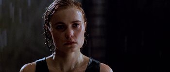 Movie still from “Pitch Black” (2000), directed by David Twohy – A person with wet hair; Close Up shot, Low angle