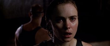 Movie still from “Pitch Black” (2000), directed by David Twohy – A person with wet hair; Close Up shot, Over the shoulder angle