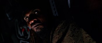 Movie still from “Pitch Black” (2000), directed by David Twohy – A person with a beard; Close Up shot, Low angle