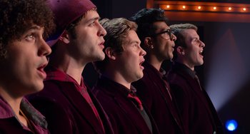Movie still from “Pitch Perfect” (2012), directed by Jason Moore – A group of young men singing together in a choir room; Close Up shot, Low angle