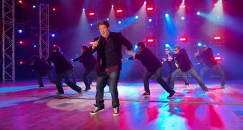 Movie still from “Pitch Perfect” (2012), directed by Jason Moore – A group of men are performing on a stage; Wide shot, High angle