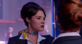 Movie still from “Pitch Perfect” (2012), directed by Jason Moore – A woman wearing a neck scarf talking to another woman; Close Up shot, Over the shoulder angle