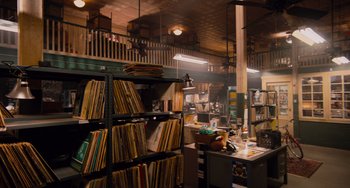 Movie still from “Pitch Perfect” (2012), directed by Jason Moore – A room filled with lots of shelves filled with records; Extreme Wide shot, High angle