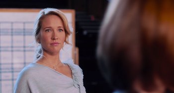 Movie still from “Pitch Perfect” (2012), directed by Jason Moore – A woman looking into a mirror while wearing a necklace; Close Up shot, Over the shoulder angle