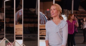 Movie still from “Pitch Perfect” (2012), directed by Jason Moore – A woman standing in front of a window; Medium shot, Over the shoulder angle