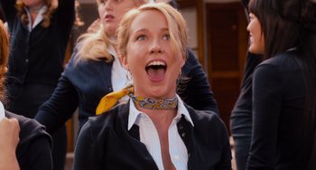 Movie still from “Pitch Perfect” (2012), directed by Jason Moore – A woman wearing a neck tie and a jacket; Close Up shot, Low angle
