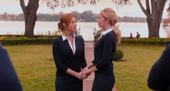Movie still from “Pitch Perfect” (2012), directed by Jason Moore – A couple of women standing next to each other; Medium shot, Low angle