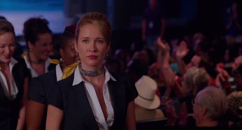 Movie still from “Pitch Perfect” (2012), directed by Jason Moore – A woman in a black jacket and a white neck tie; Close Up shot, Over the shoulder angle