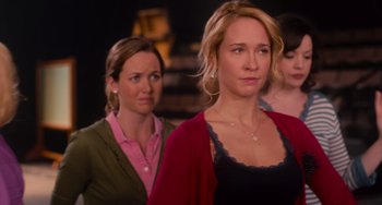 Movie still from “Pitch Perfect” (2012), directed by Jason Moore – A group of women standing next to each other in a room; Close Up shot, Over the shoulder angle