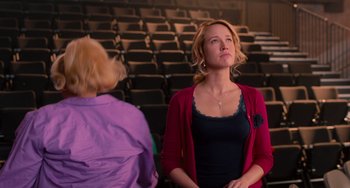Movie still from “Pitch Perfect” (2012), directed by Jason Moore – Two women are standing in front of a row of seats; Medium shot, Low angle