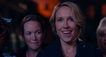 Movie still from “Pitch Perfect” (2012), directed by Jason Moore – Two women smiling for the camera in a dark room; Close Up shot, Over the shoulder angle