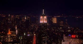 Movie still from “Pitch Perfect” (2012), directed by Jason Moore – A view of the empire state building lit up at night; Extreme Wide shot, High angle