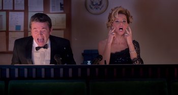 Movie still from “Pitch Perfect” (2012), directed by Jason Moore – A man and a woman sitting in front of microphones; Medium shot, Low angle
