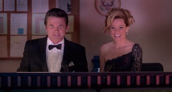 Movie still from “Pitch Perfect” (2012), directed by Jason Moore – A man and a woman sitting in front of a piano; Medium shot, Low angle