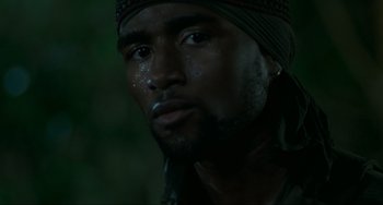 Movie still from “Platoon” (1986), directed by Oliver Stone – A person with a bandanna on; Close Up shot, Low angle