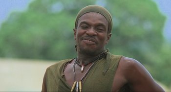 Movie still from “Platoon” (1986), directed by Oliver Stone – A man in a green shirt and a hat; Close Up shot, Low angle