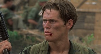 Movie still from “Platoon” (1986), directed by Oliver Stone – A person wearing a uniform; Close Up shot, Low angle