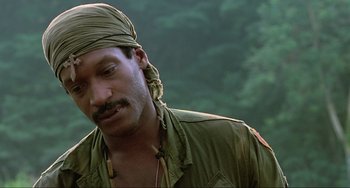 Movie still from “Platoon” (1986), directed by Oliver Stone – A person wearing a head scarf; Close Up shot, Low angle