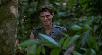 Movie still from “Platoon” (1986), directed by Oliver Stone – A man standing in the middle of a forest; Close Up shot, Low angle