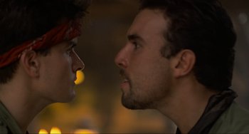 Movie still from “Platoon” (1986), directed by Oliver Stone – Two men face to face in a dark room; Close Up shot, Low angle