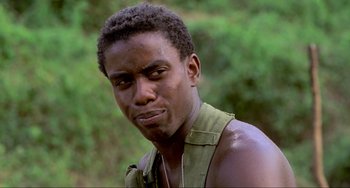 Movie still from “Platoon” (1986), directed by Oliver Stone – A person wearing a shirt; Close Up shot, Low angle