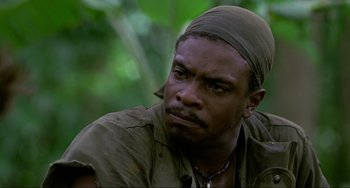 Movie still from “Platoon” (1986), directed by Oliver Stone – A person wearing a head scarf; Close Up shot, Low angle