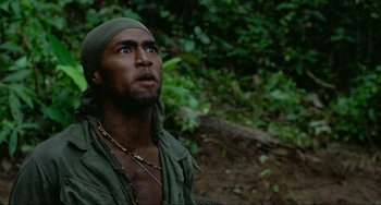 Movie still from “Platoon” (1986), directed by Oliver Stone – A man with a beard is looking up in the woods; Close Up shot, Low angle