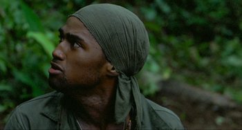 Movie still from “Platoon” (1986), directed by Oliver Stone – A person wearing a head scarf; Close Up shot, Low angle