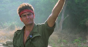 Movie still from “Platoon” (1986), directed by Oliver Stone – A man with a red bandana on his head; Close Up shot, Low angle