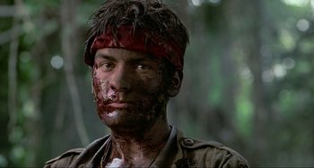 Movie still from “Platoon” (1986), directed by Oliver Stone – A person with a bandage on his head; Close Up shot, Low angle