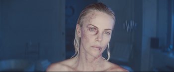 Movie still from “Atomic Blonde” (2017), directed by David Leitch – A person with makeup on; Close Up shot, Over the shoulder angle