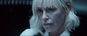 Movie still from “Atomic Blonde” (2017), directed by David Leitch – A person with long white hair; Close Up shot, Over the shoulder angle