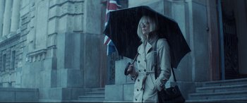 Movie still from “Atomic Blonde” (2017), directed by David Leitch – A woman in a trench coat holding an umbrella; Medium shot, Low angle